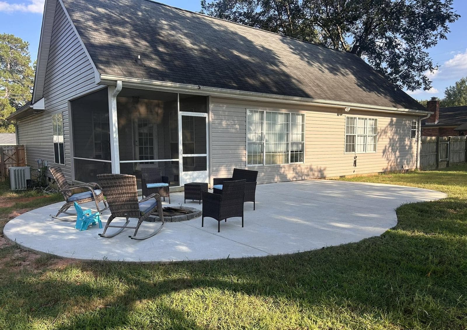 Finished concrete patio with a stacked-stone fire pit and seating area