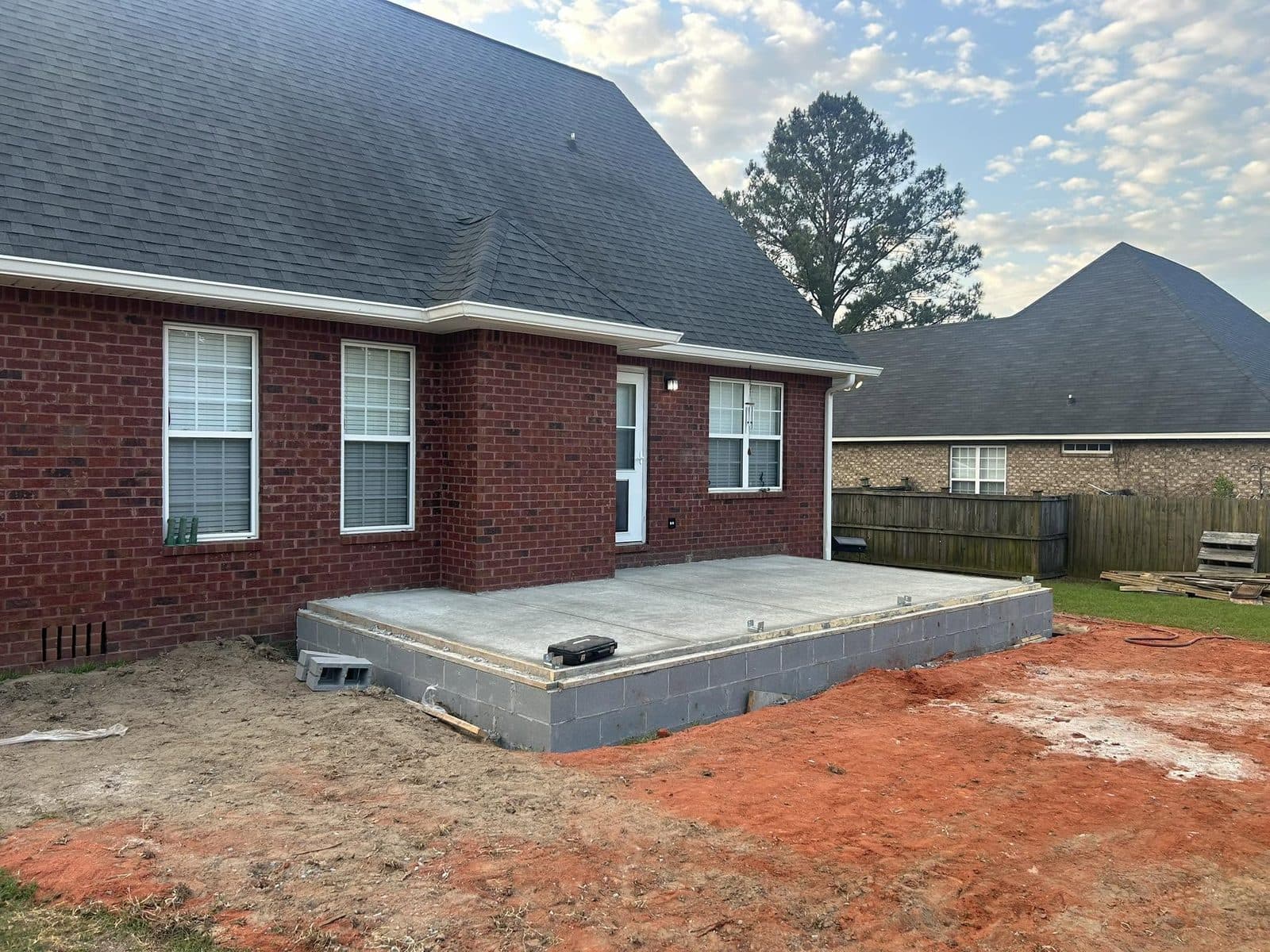 Concrete slab foundation prepared for a covered back patio addition, before construction